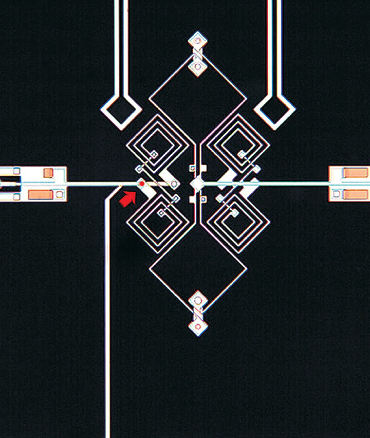 A superconducting qubit, the kind of circuit Google’s chips are made of, under a microscope at NIST in 2005; the red arrow points to its heart